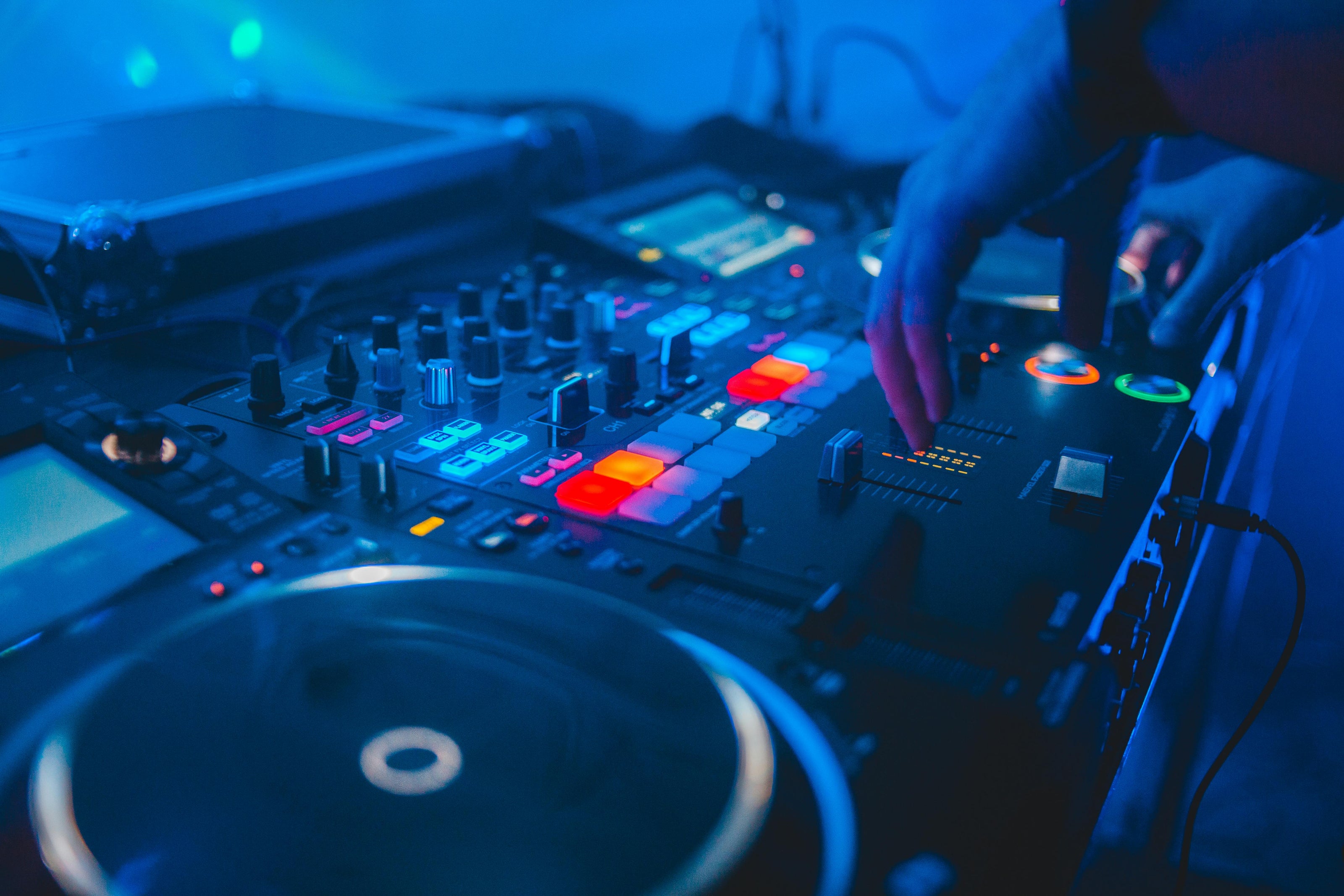 DJ mixing on audio console with glowing controls – change lyrics with AI concept